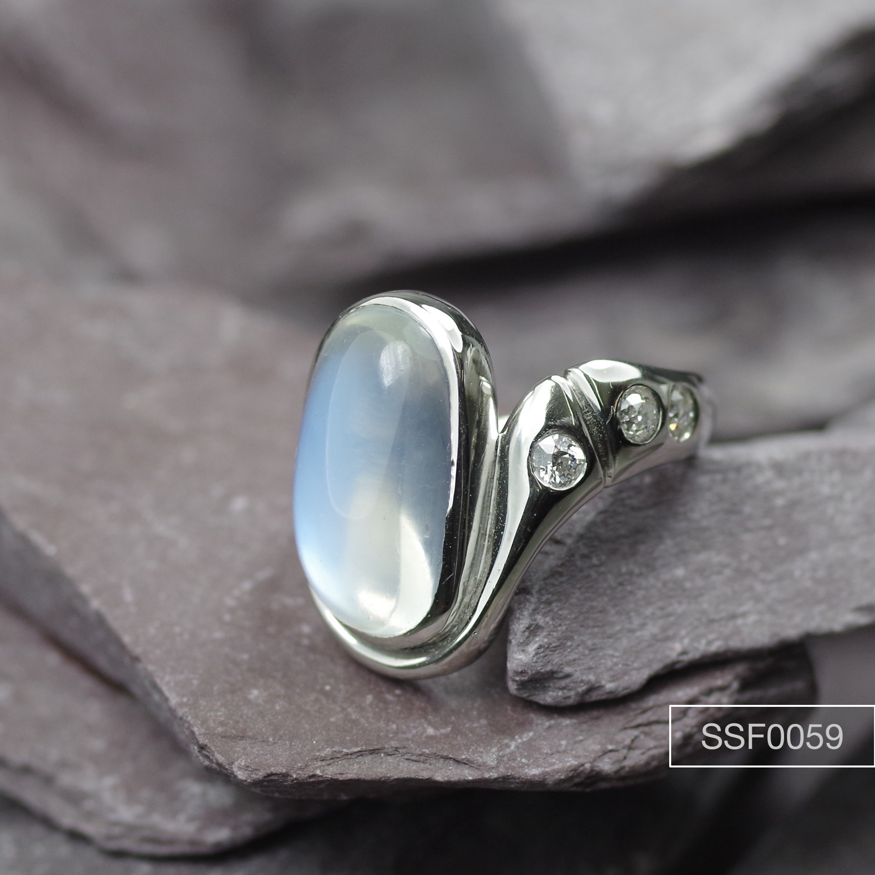 Moonstone ring with flanking Diamonds.