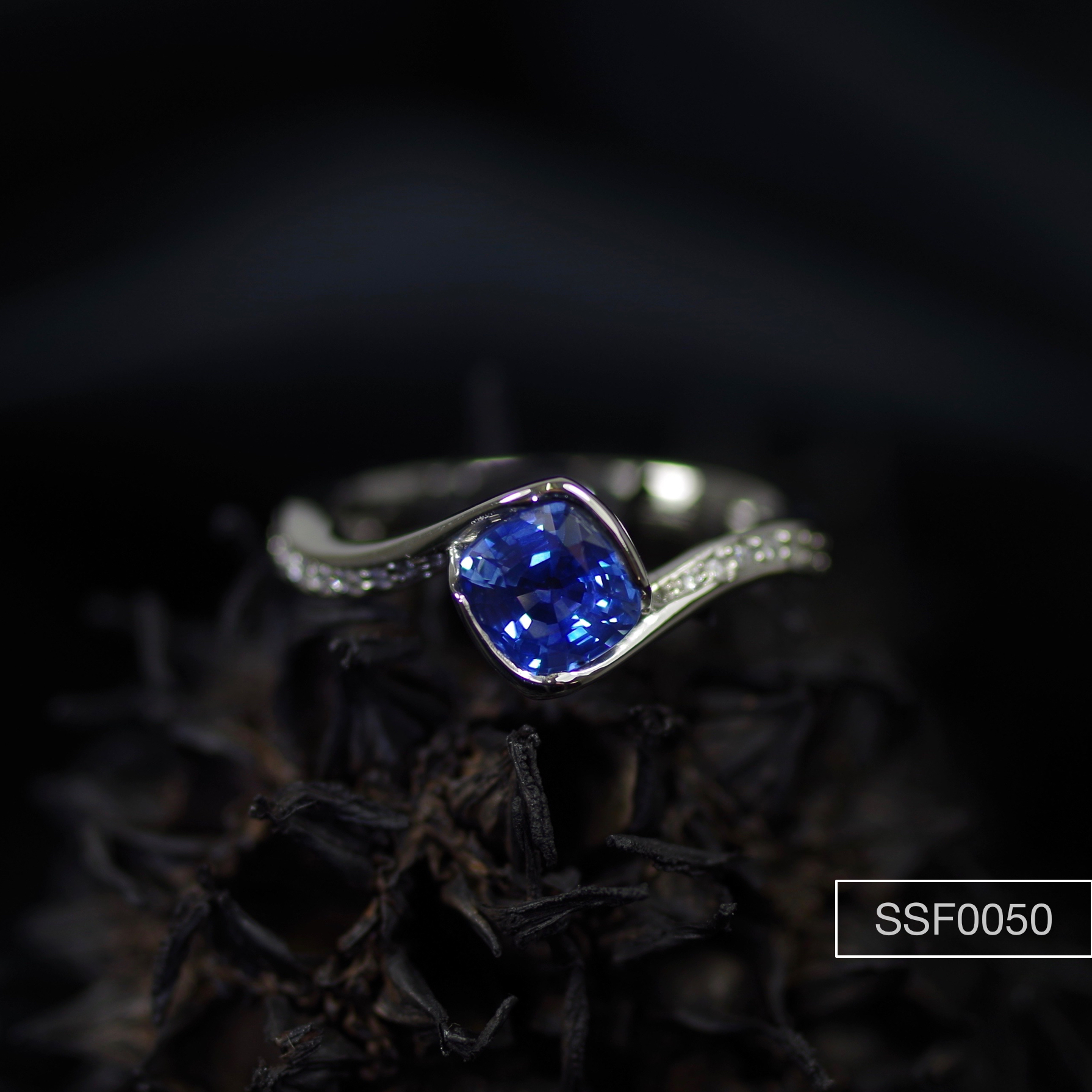 1.07ct Cushion cut Sapphire set in a Platinum ring with flanking Diamonds.